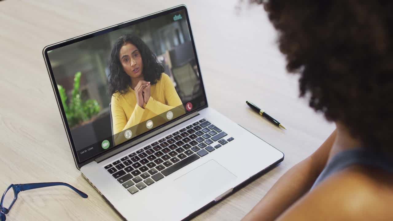 African american businesswoman using laptop for video call with biracial business colleague