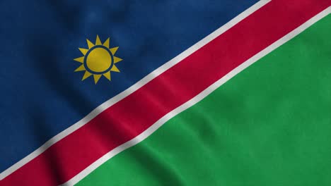 la bandera de namibia ondeando en el viento. la bandera nacional de namibia. el signo de namibia animación de bucle sin costuras. 4k