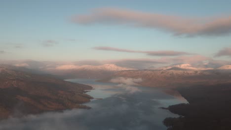 static shot of loch katrine from ben a'an with snowy mountain tops at winter