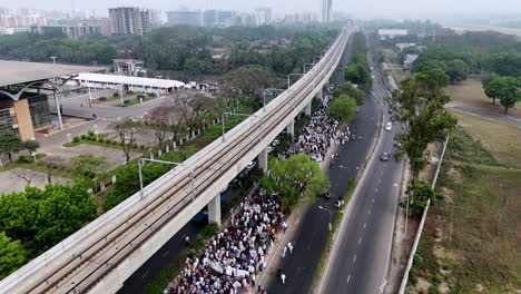 aerial cinematic drone shot of muslims walking from a mosque after prayer in bangladesh.