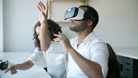 slow motion of cheerful workers testing vr headset