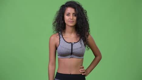 young beautiful hispanic woman with gym clothes giving thumbs up