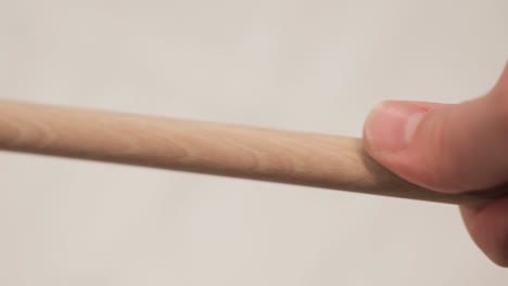 hand holding a wooden utensil