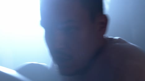 close up of a boxer trains in a training room with a punching bag