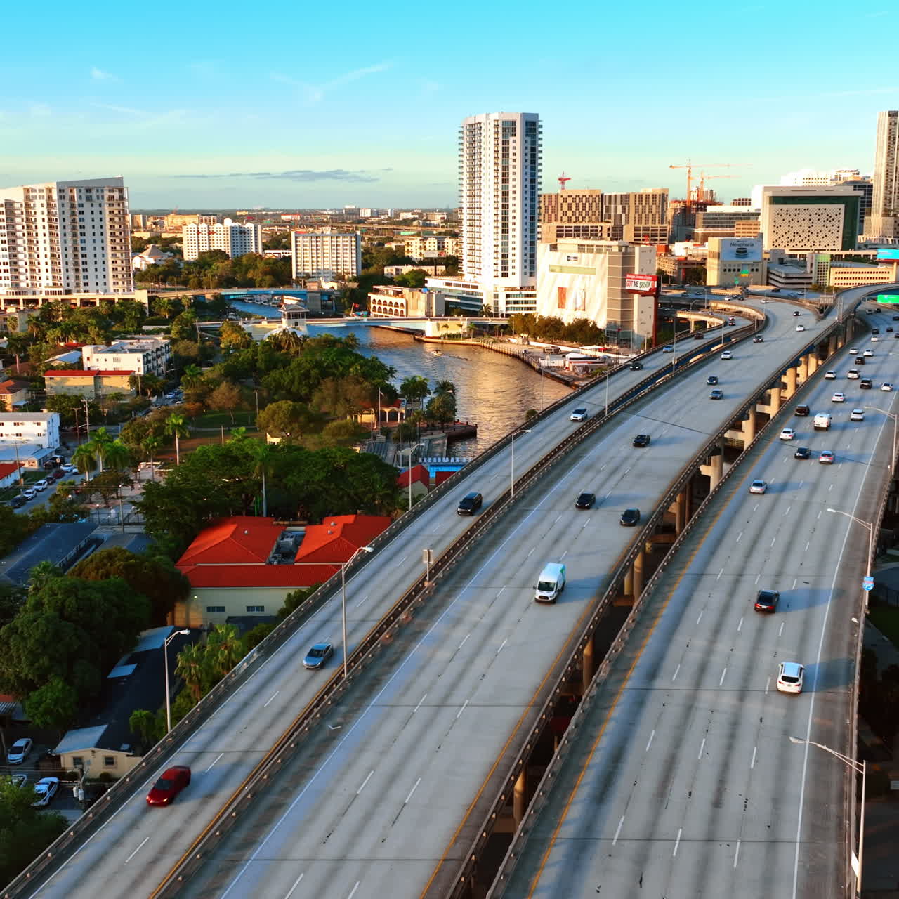 Flying above the highways and cars running by. Lovely view of sunny Miami in Florida, USA.