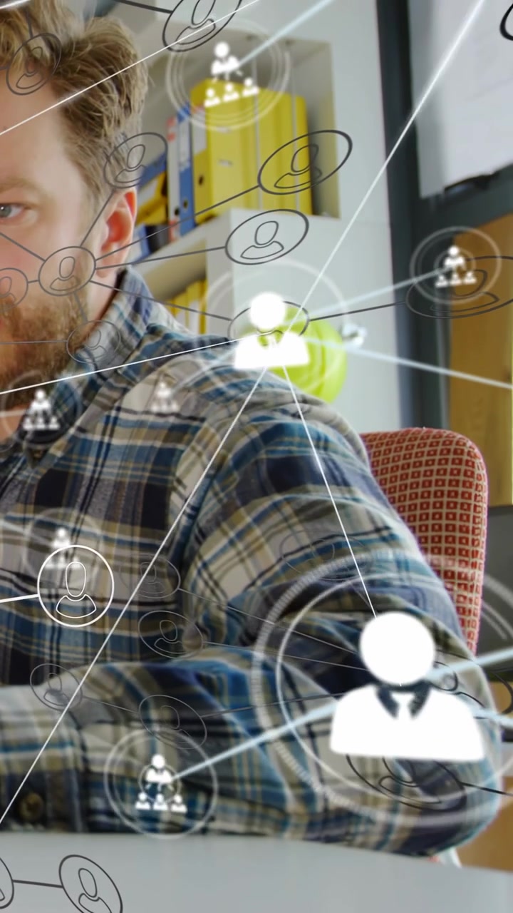 Vertical video: Man typing and reaching at desk in IT office causing network nodes mapping contacts
