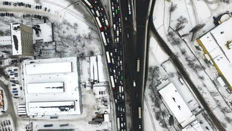 top view cars driving winter highway. aerial view traffic snowy highway junction