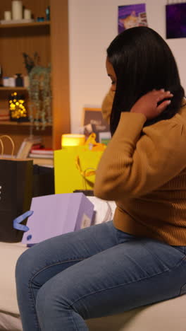 woman sitting on a bed with shopping bags