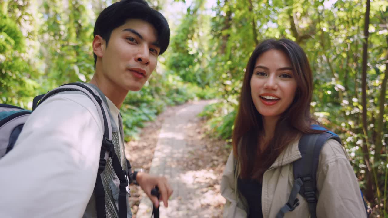 부부 가 울창 한 숲 에서 산책 하고 있다