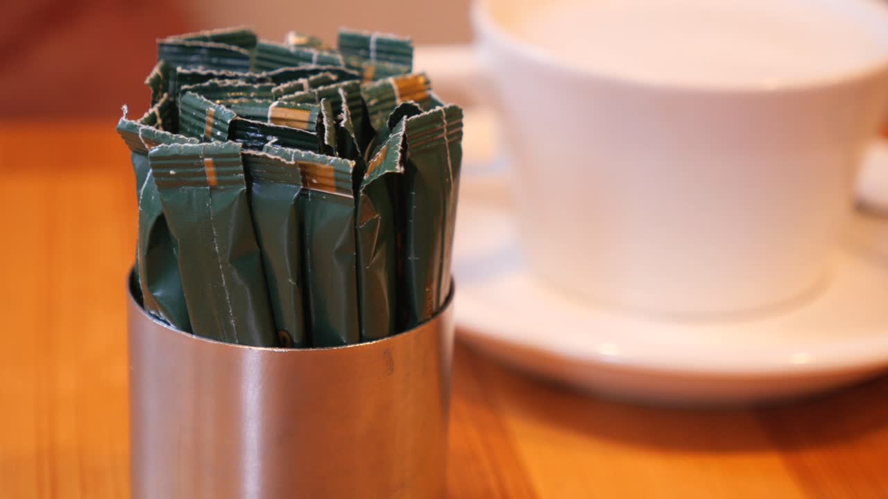 Sugar Packets and Coffee Cup