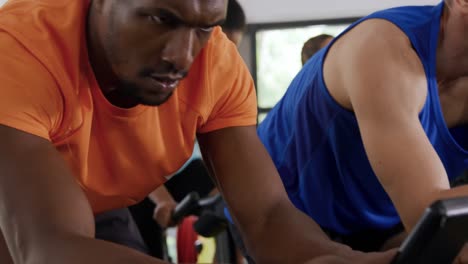 working out on exercise bikes at a gym