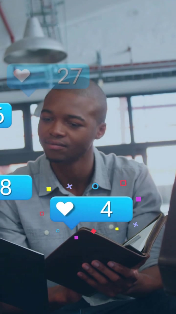 Vertical video: Man flipping notebook at desk, blue bubbles rising over pages during marketing