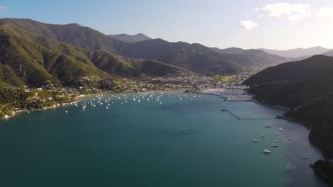 Sailboats-Floating-At-Tranquil-Blue-Water-Of-Waikawa-Bay-With-Waikawa-Marina-In-Picton,-New-Zealand