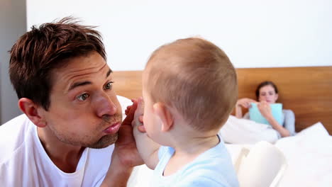 Happy-father-playing-with-his-baby-son