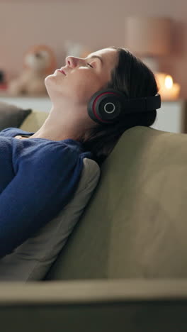 woman relaxing on the couch listening to music