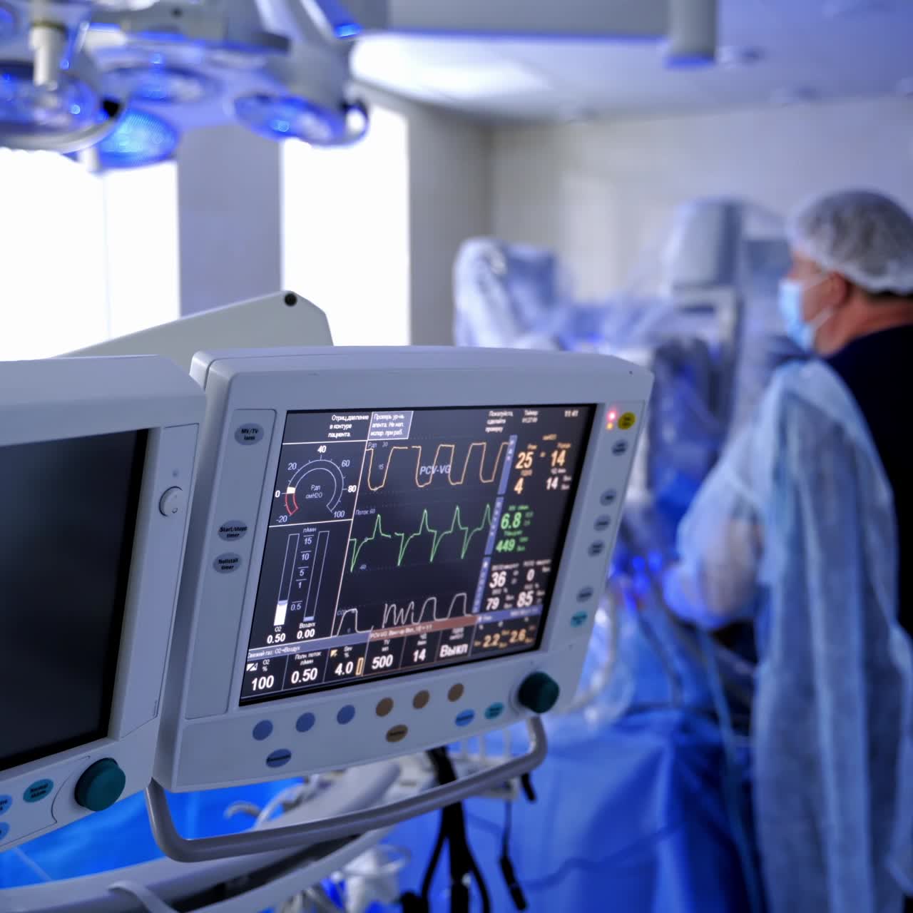 Medical monitor on robotic surgery background. Patient's condition on the screen. High-tech medical equipment in the operating room.