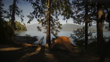 timelapse of moonlight creeping across camp site and tent on the lake front