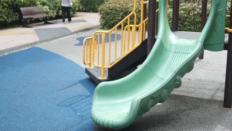 park playground slide with a person walking