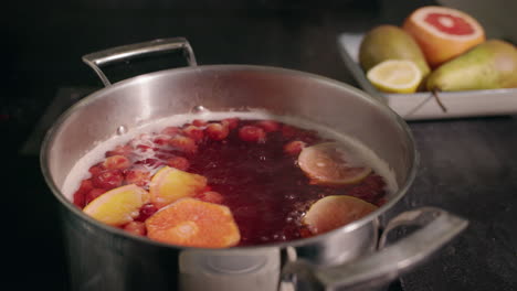 making a festive cranberry and citrus hot drink