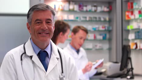 Senior-doctor-smiling-at-camera