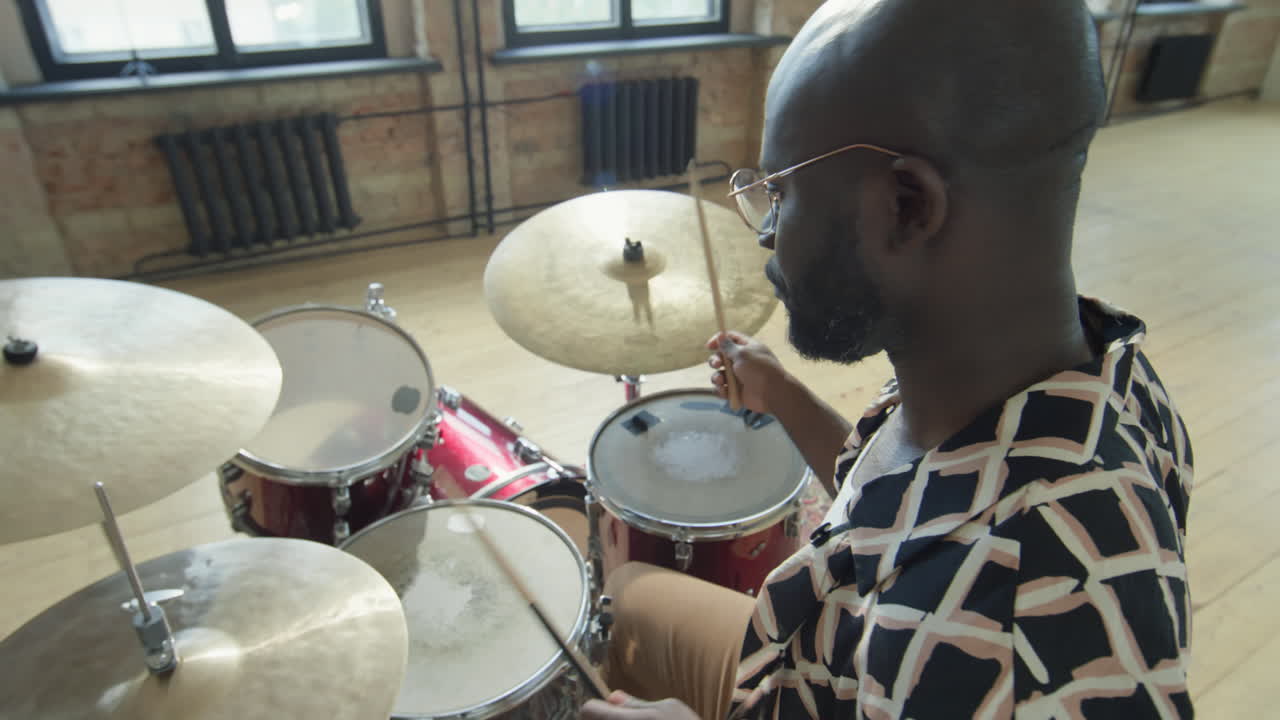 African American Musician Playing Drums in Rehearsal Studio