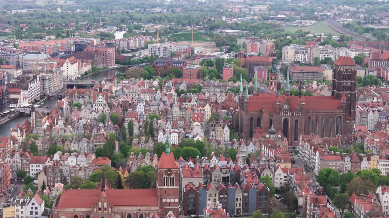 Fly towards Saint John’s Church and St. Mary's Church in Gdansk, Poland