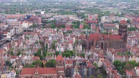 fly towards saint john’s church and st. mary's church in gdansk, poland