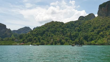 Scenic-View-Departing-Railay-Beach-with-Mountainous-Limestone-Rocks-Along-the-Coastline-of-Krabi,-Thailand