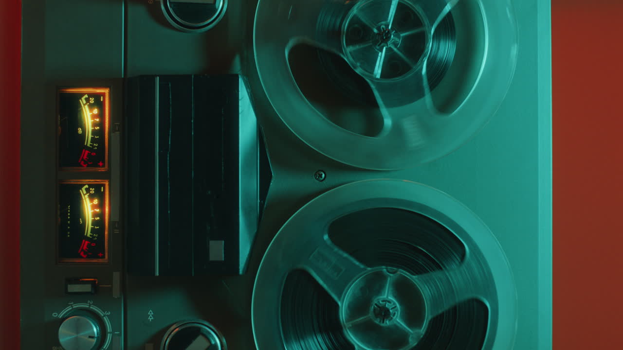 Close-Up of Retro Reel-to-Reel Tape Recorder in Colorful Neon Light