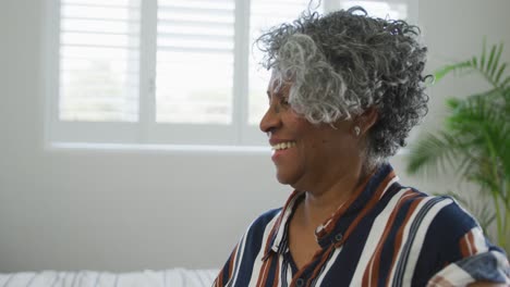 happy african american senior woman showing covid vaccinate passport