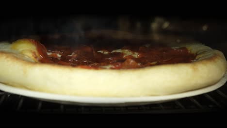Pepperoni-pizza-pie-baking-in-the-oven---bubbling-gooey-cheese-melting-time-lapse