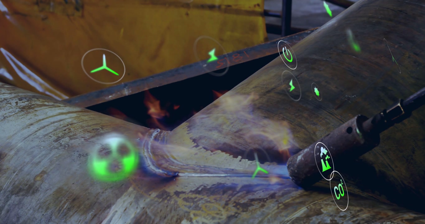 Welder igniting torch and welding seam to join pipe sections in fabrication while holograms rising