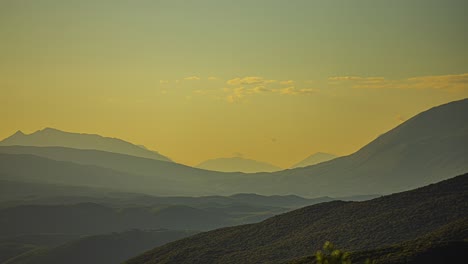 shades of mountains in greek countryside, static time lapse with yellow tint