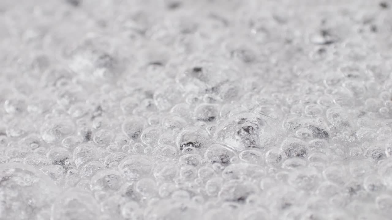 Close up of boiling sugar with bubbles turns into caramel, caramelization, chef cooking dessert in cafe, restaurant pastry food.