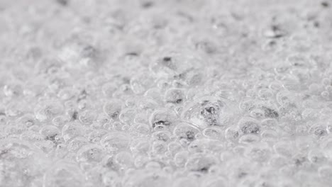 close up of boiling sugar with bubbles turns into caramel, caramelization, chef cooking dessert in cafe, restaurant pastry food.