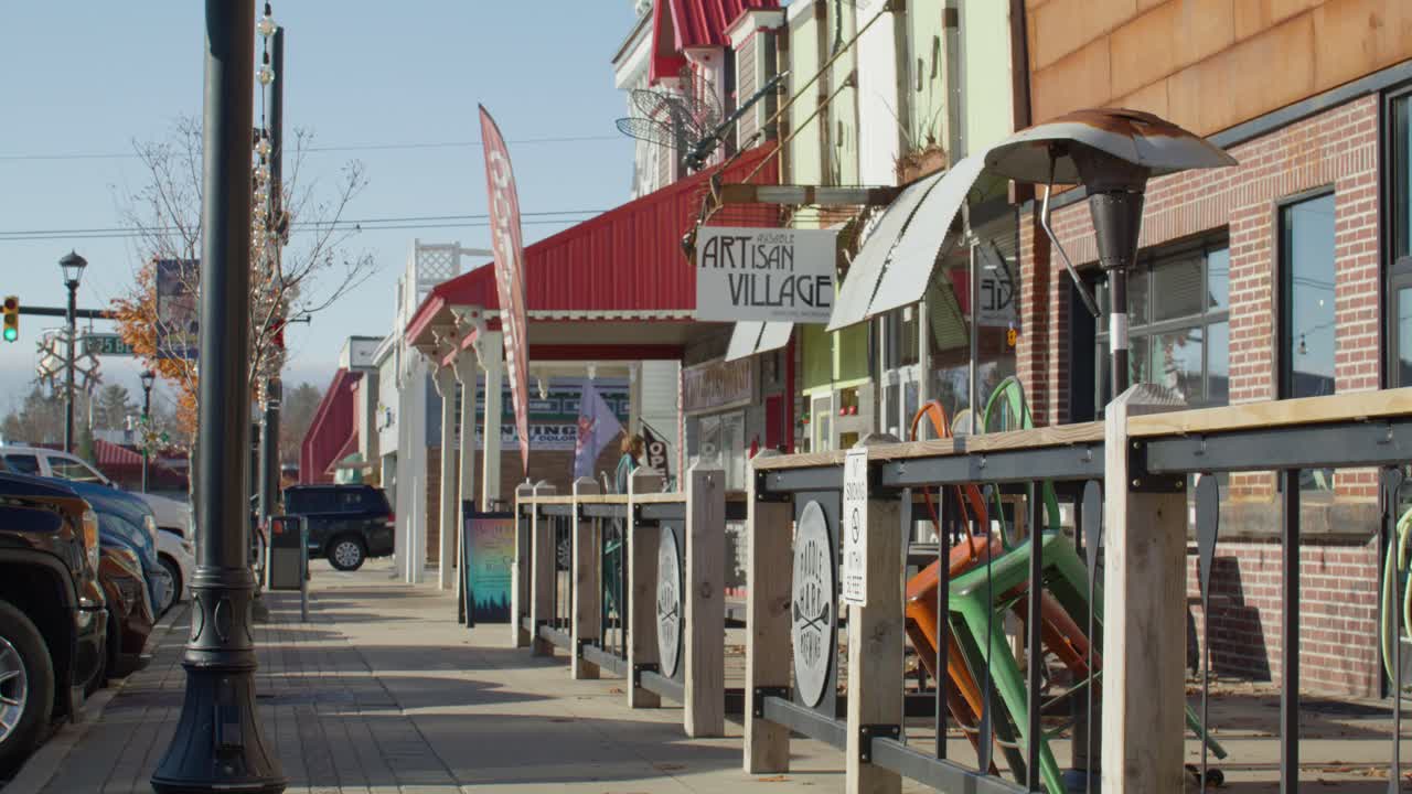 Downtown Grayling, Michigan with stable side medium view of business district.