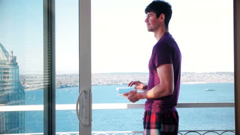 Man-using-digital-tablet-in-balcony-4k