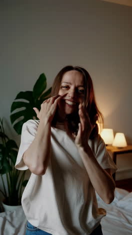 woman smiling in a bedroom