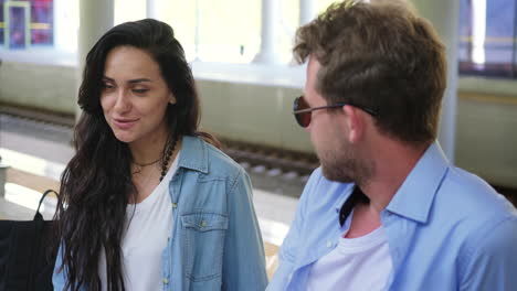 couple talking at a train station