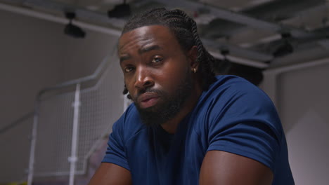 close up portrait of determined male athlete sport training in gym sitting and concentrating in changing room with focused expression 7