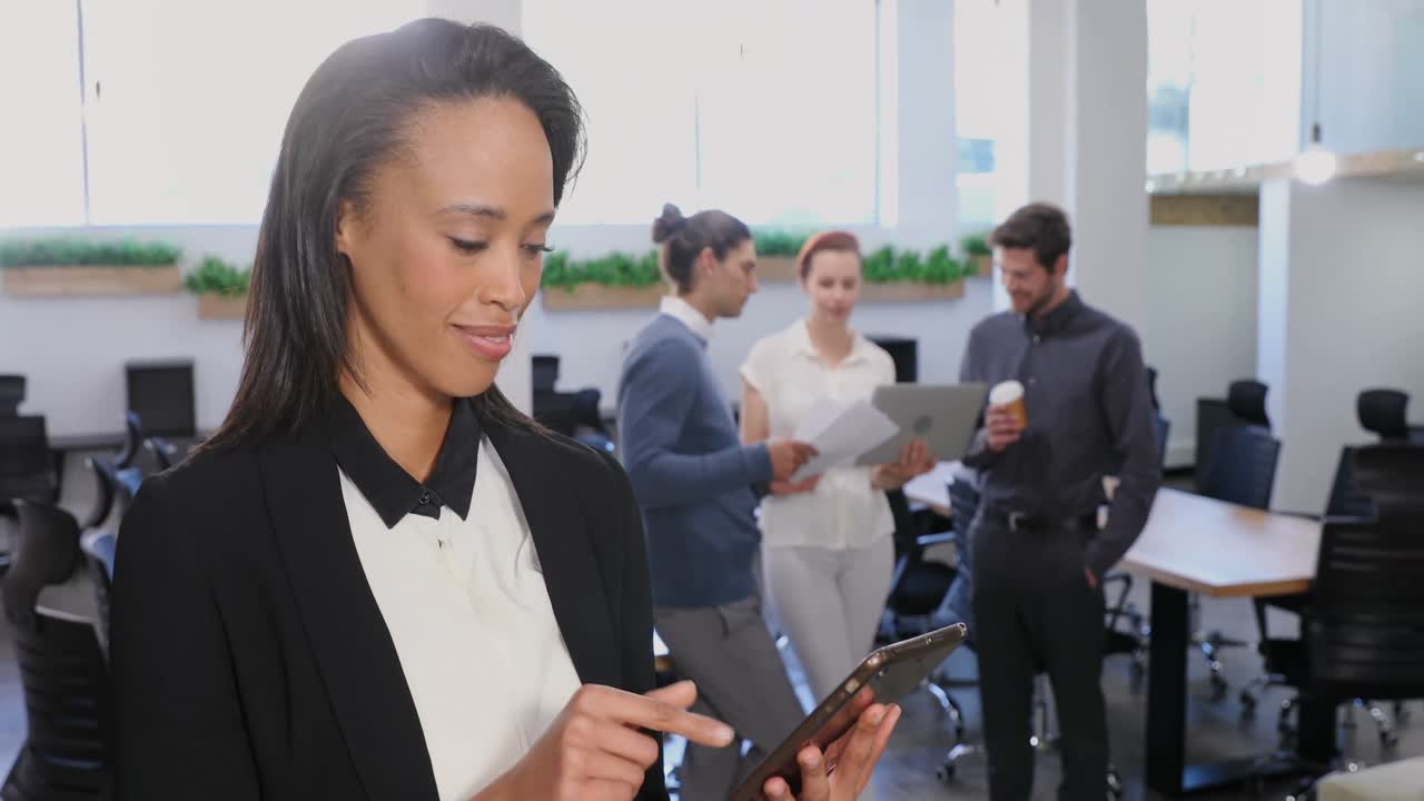 Female executive using digital tablet in office 4k