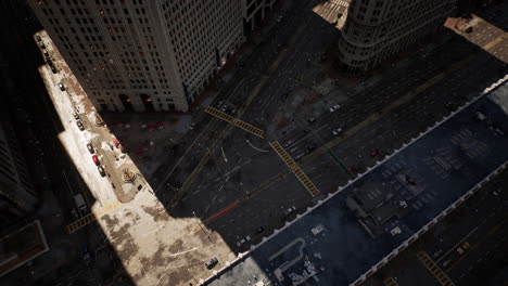 aerial view of a city street with buildings, cars, and traffic