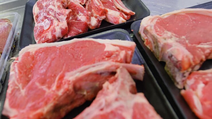 Raw red meat in container