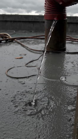 water draining from rooftop gutter