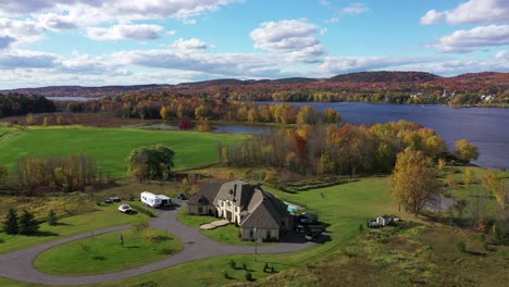 expensive and wealthy home on the water surrounded by fall colors