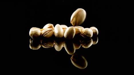 Pistachios-falling-on-black-background-4k