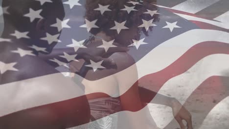 Multi-races-couple-at-the-beach-with-US-flag-waving-foreground