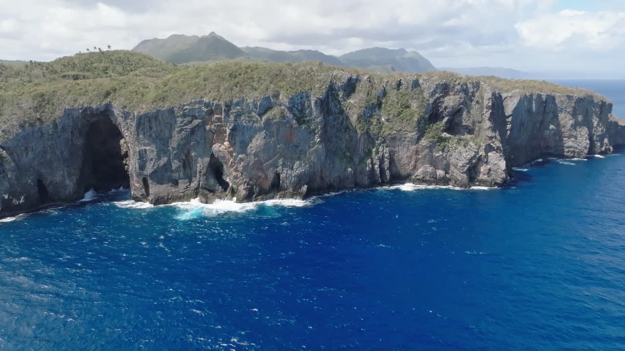 Aerial wide shot of Nationalpark Cabo Cabr&oacute;n with rocky coastline and blue Caribbean Sea during cloudy day