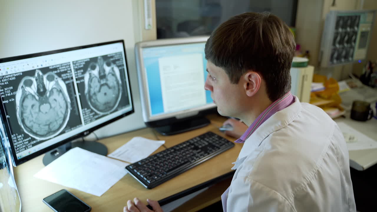Physician Using Computer In Hospital Office. Professional medical doctor working in hospital office using computer technology
