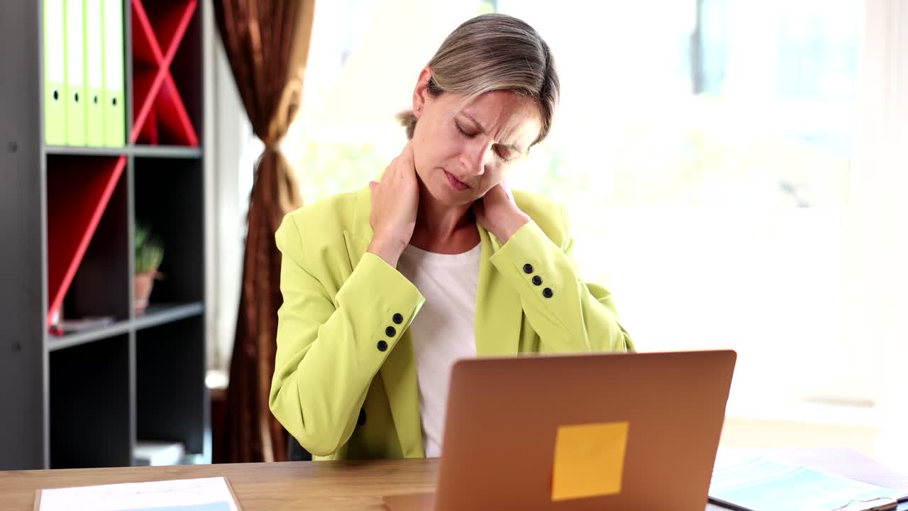 Woman with Neck Pain Working on Laptop